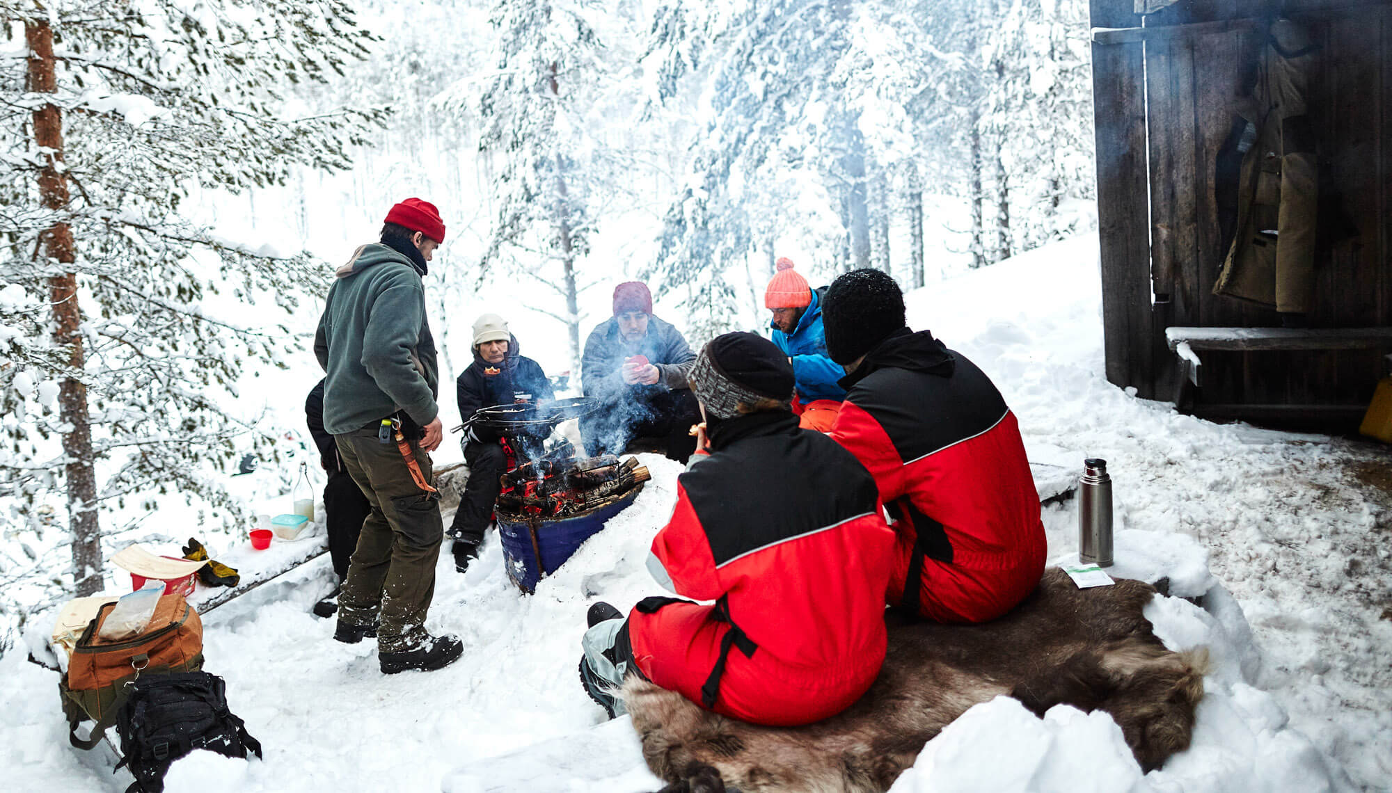 Outdoor lunch break during a dog sledding trek adventure in Swedish Lapland